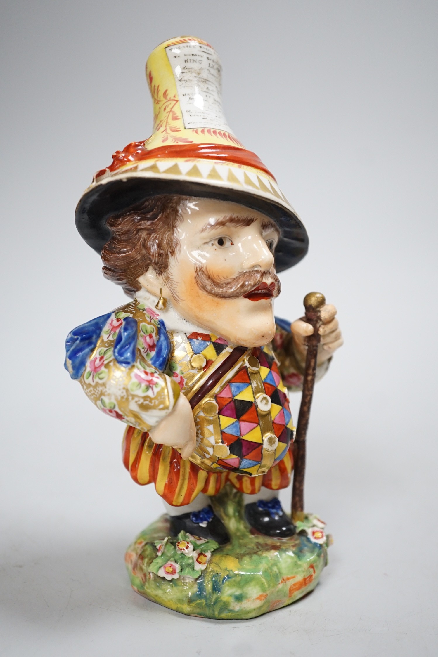 A Derby Mansion House Dwarf holding a walking stick, his hat with advertising, incised 227, c.1790-1800